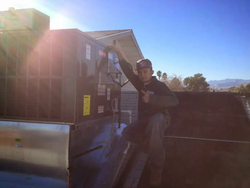 HVAC technician performing HVAC Inspection on a rooftop unit in Pittstown